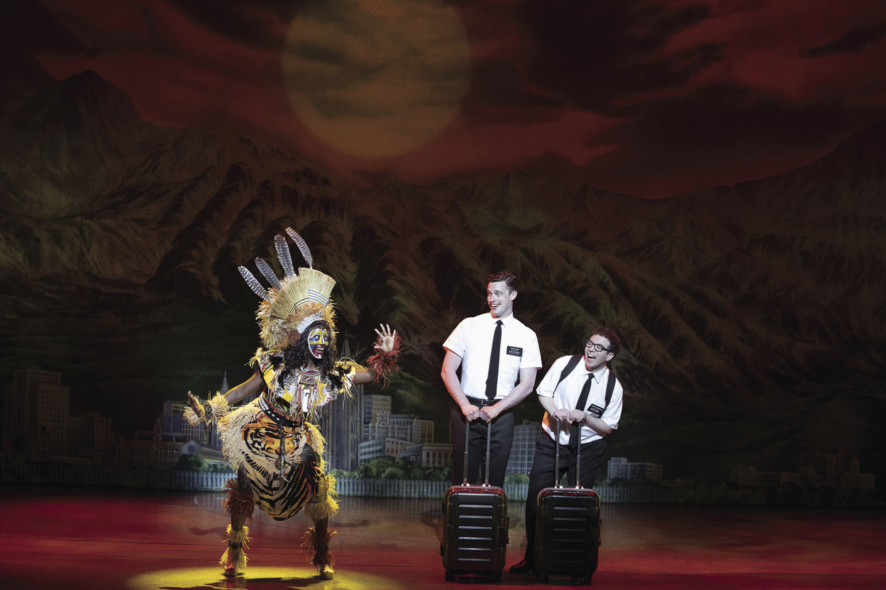 L-R: Tsilala Brock, Liam Tobin and Jordan Matthew Brown in “The Book of Mormon.” With book, music and lyrics by Trey Parker, Robert Lopez and Matt Stone, choreography by Casey Nicholaw and direction by Nicholaw and Parker, “The Book of Mormon” will be presented by Center Theatre Group at the Ahmanson Theatre February 18 through March 29, 2020. For more information, please visit CenterTheatreGroup.org. Press Contact: CTGMedia@CTGLA.org / (213) 972-7376. Photo by Julieta Cervantes.